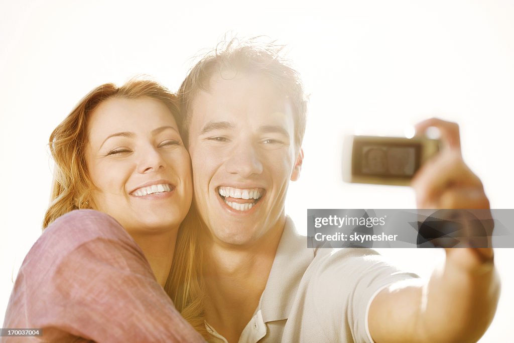 Cheerful couple in love taking a photo.