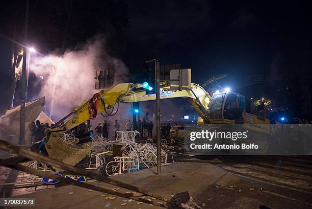 Protestors use heavy machines to fight Istanbul police to reach the Prime Minister's building June 2, 2013 in Istanbul, Turkey. People started...