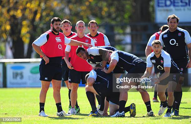 England coach Stuart Lancaster looks on as scrum half Richard Wigglesworth releases the ball during England training at the Jockey Club on June 6,...