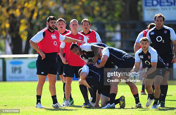 England coach Stuart Lancaster looks on as scrum half Richard Wigglesworth releases the ball during England training at the Jockey Club on June 6,...