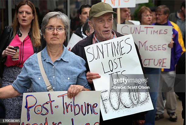 Demonstrators, including union members, reporters, and photographers march outside the offices of the Chicago Sun-Times protesting the newspapers...