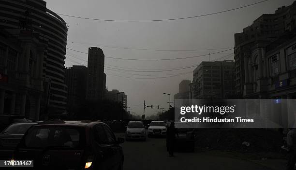 Traffic moving at Connaught Place during a dust storm on June 6, 2013 in New Delhi, India. Rain and strong winds lashed the capital Thursday evening...