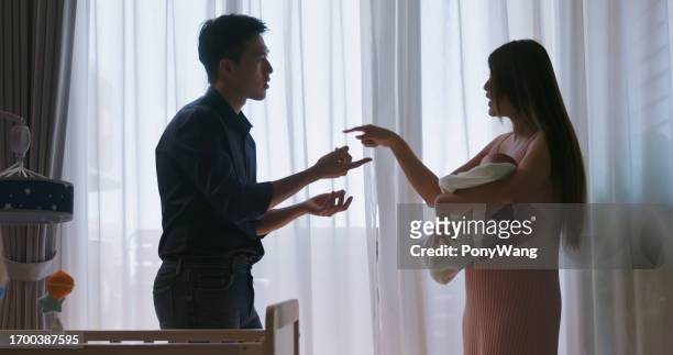 new parents have argument - asian couple arguing stockfoto's en -beelden