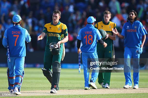 Ryan McLaren of South Africa shakes hands after his sides defeat with MS Dhoni of India during the Group B ICC Champions Trophy match between India...