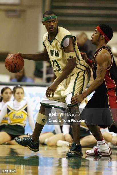 LeBron James of St. Vincent-St. Mary High School dribbles the ball against Oak Hill Academy at the Cleveland State University Convocation Center on...