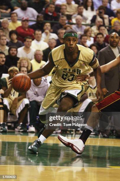 LeBron James of St. Vincent-St. Mary High School drives against Oak Hill Academy at the Cleveland State University Convocation Center on December 12,...