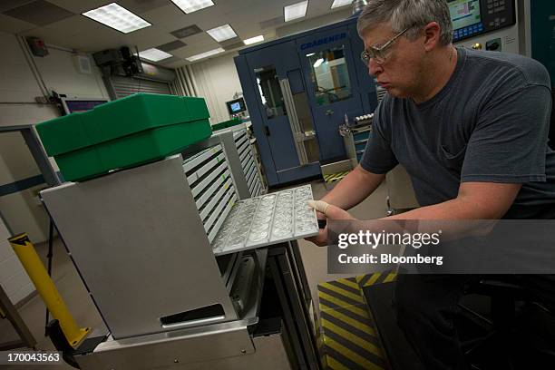 Pressman Larry Norton moves a rack of one-ounce silver bullion coins at the United States Mint at West Point in West Point, New York, U.S., on...