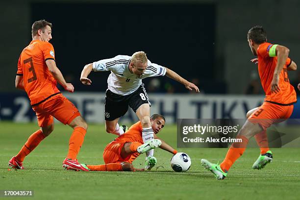 Sebastian Rode of Germany is challenged by Stefan de Vrij, Adam Maher and Kevin Strootman of Netherlands during the UEFA European Under 21...