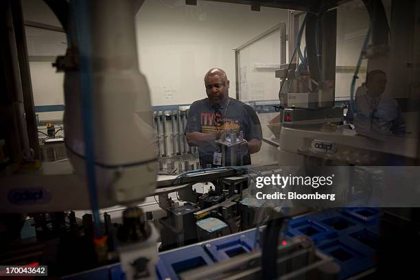 Jumel Alston works on the production line for one ounce silver bullion coins at the United States Mint at West Point in West Point, New York, U.S.,...