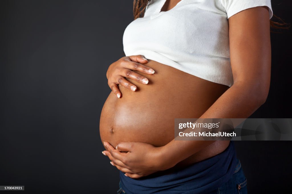 Pregnant African Woman Holding Her Belly