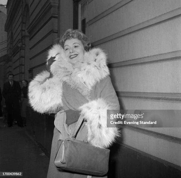 French actress Edwige Feuillere poses in her fur trimmed coat, London, February 27th, 1957.