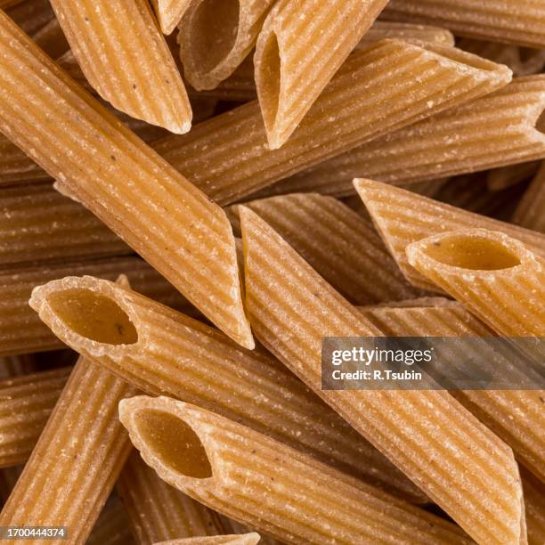 wholegrain penne pasta - vollkorn stock pictures, royalty-free photos & images