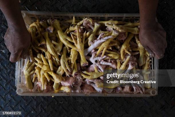 chicken feet for sale at a market - animal foot foto e immagini stock