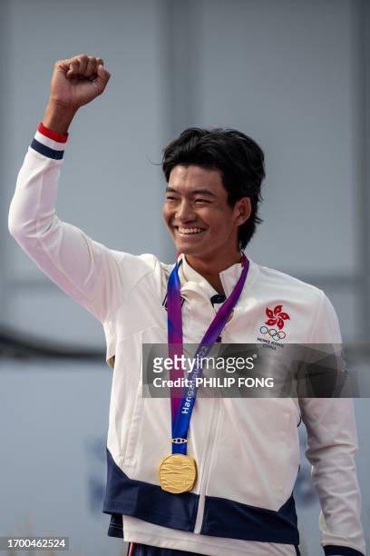 Gold medallist Hong Kong's Taichi Kho attends the medal ceremony for the men's individual golf event at the Hangzhou 2022 Asian Games in Hangzhou, in...