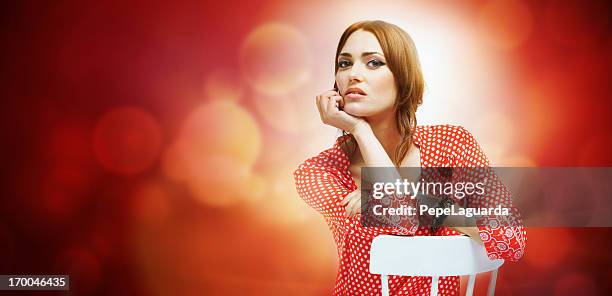 cool young woman in red background with lens flares - portrait lens flare stock pictures, royalty-free photos & images