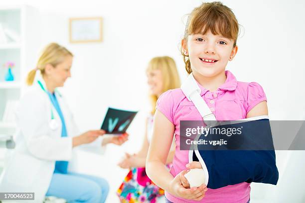 child with broken arm at doctors office. - broken trust stock pictures, royalty-free photos & images