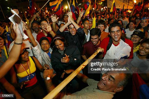 Venezuelan man does the limbo dance during a candlelight march and rally that drew nearly half a million protesters demanding early elections or...