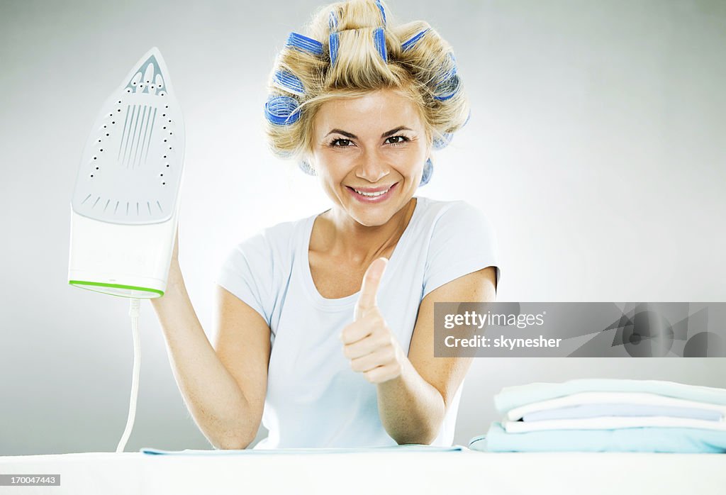 Smiling housewife with her thumb up