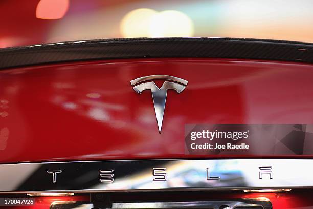 Tesla motor company car logo sits on a car in a dealership at the Dadeland Mall on June 6, 2013 in Miami, Florida. The electric car maker is trying...