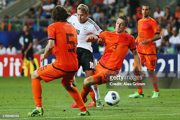 Lewis Holtby of Germany scores his team's second goal against Stefan de Vrij and Daley Blind of Netherlands during the UEFA European Under 21...