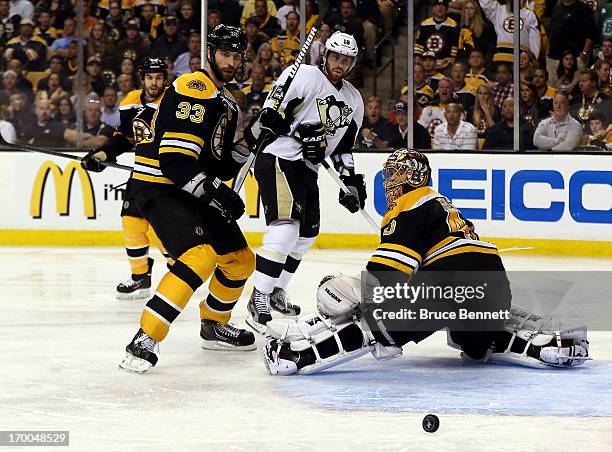 Zdeno Chara and Tuukka Rask of the Boston Bruins look on as a shot by the Pittsburgh Penguins goes wide during Game Three of the Eastern Conference...