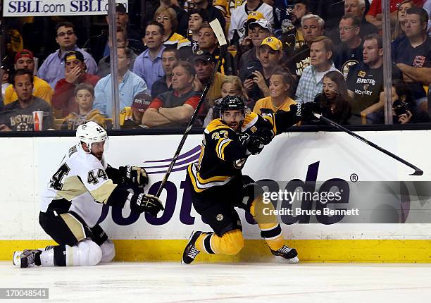 Brooks Orpik of the Pittsburgh Penguins checks Patrice Bergeron of the Boston Bruins during Game Three of the Eastern Conference Final of the 2013...