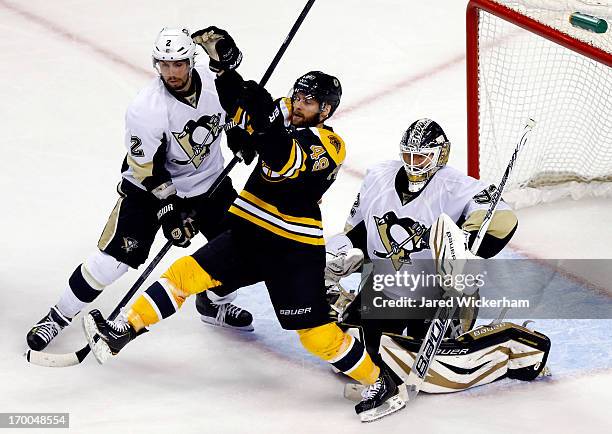 Rich Peverley of the Boston Bruins and Matt Niskanen of the Pittsburgh Penguins battle for position in front of the net during Game Three of the...