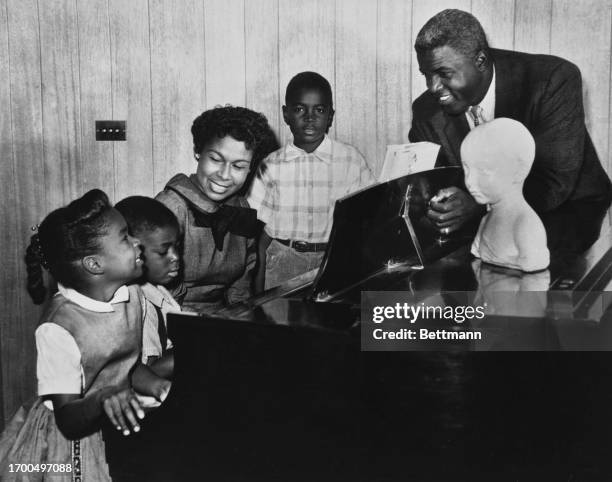 Former baseball player Jackie Robinson and family posing for a photograph at their home in Stamford, Connecticut, January 16th 1958. Left to right:...