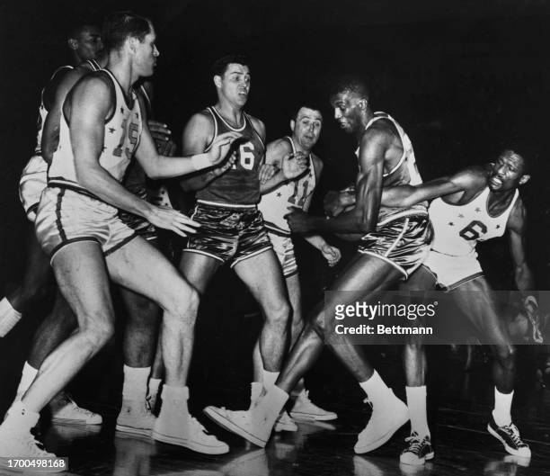 Bill Russell tied up Walter Dukes long enough to win a jump ball during the first quarter of the NBA all-Star game in Syracuse, New York, January...