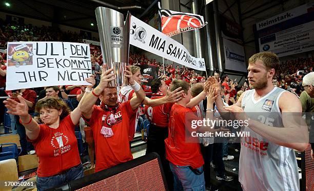 Anton Gavel of Bamberg gives high fives to the fans and walks passt a replica of the Beko BBL Cup after game 5 of the semifinals of the Beko BBL...