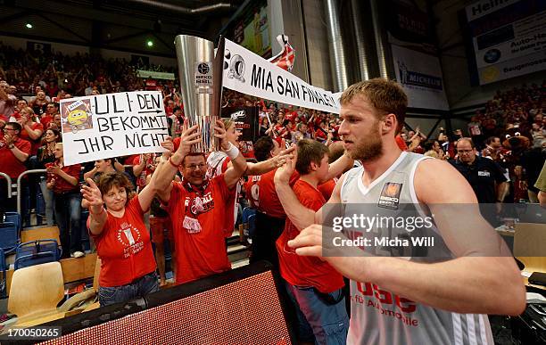 Anton Gavel of Bamberg gives high fives to the fans and walks passt a replica of the Beko BBL Cup after game 5 of the semifinals of the Beko BBL...