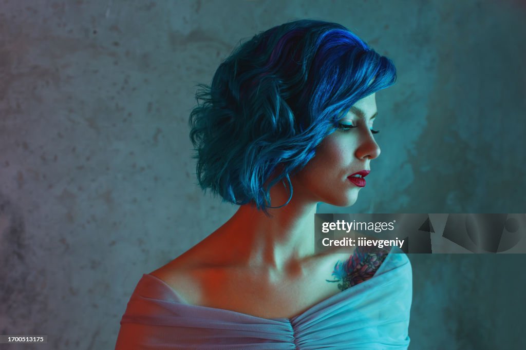 Blue hair woman in studio.