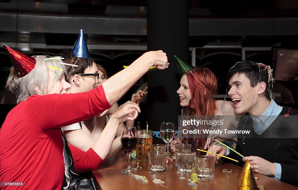 Mixed group of people get silly at a party