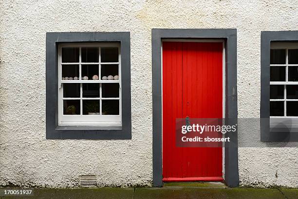house with red door in east neuk of fife, scotland - east door stock pictures, royalty-free photos & images