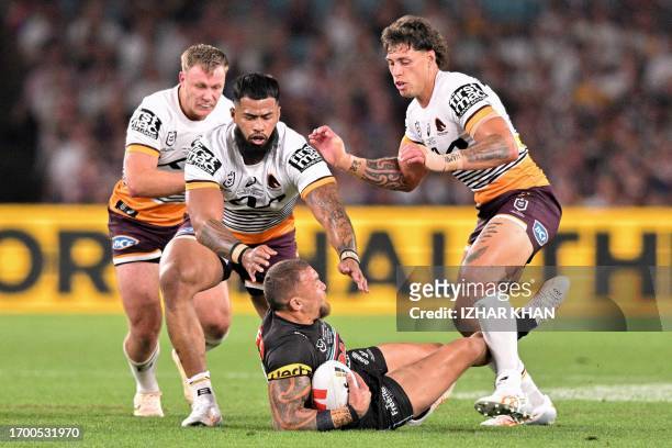 James Fisher-Harris of the Panthers is tackled during the 2023 NRL Grand Final match between Penrith Panthers and Brisbane Broncos at Accor Stadium...