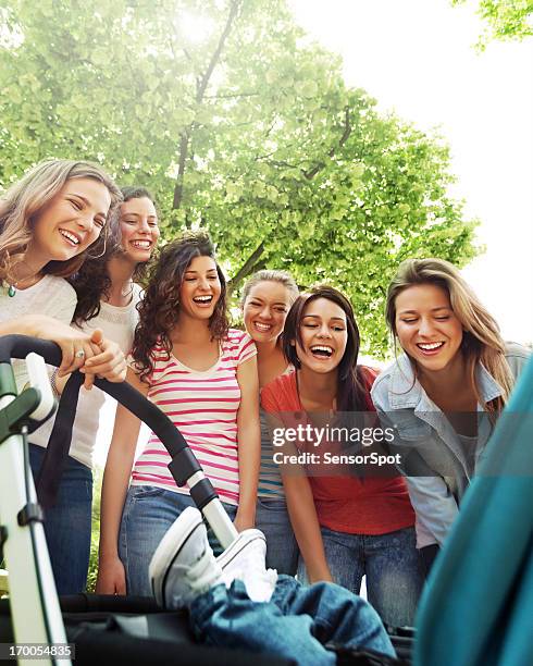 young women smiling to a baby - teen pregnancy stock pictures, royalty-free photos & images