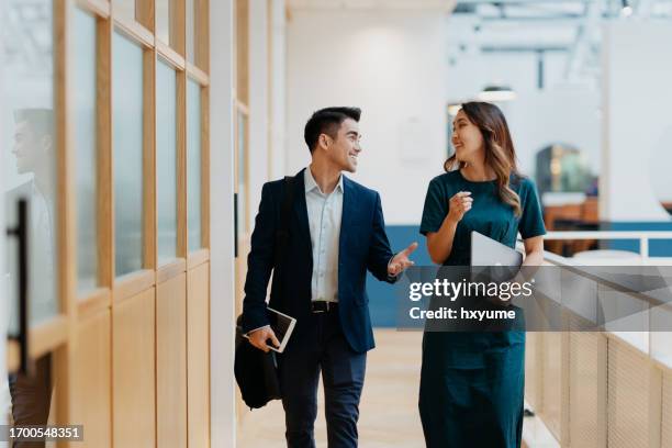 businessman and businesswoman in the office - malaysian stock pictures, royalty-free photos & images