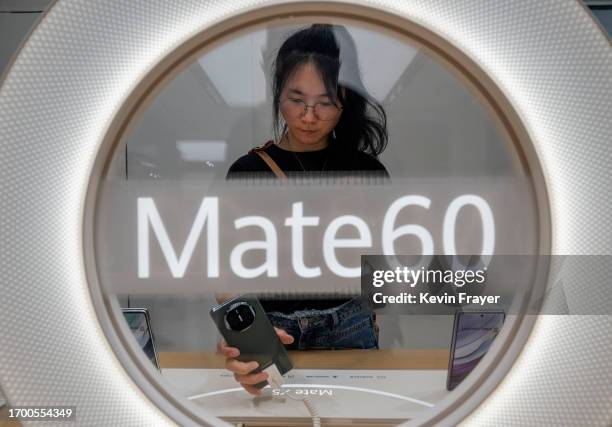 Customer looks at a newly launched Mate 60 smartphone at a Huawei flagship store after the company unveiled new products on September 25, 2023 in...