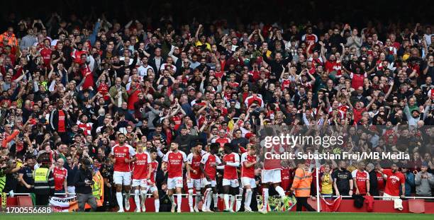Bukayo Saka of Arsenal FC celebrate with a fans after scoring 2nd goal during the Premier League match between Arsenal FC and Tottenham Hotspur at...