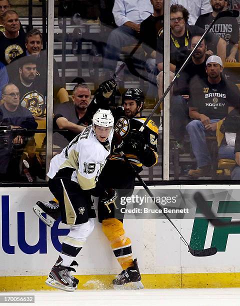 Beau Bennett of the Pittsburgh Penguins checks Adam McQuaid of the Boston Bruins during Game Three of the Eastern Conference Final of the 2013 NHL...