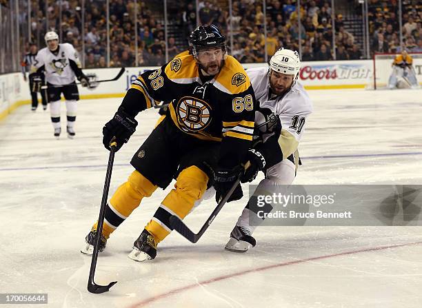 Jaromir Jagr of the Boston Bruins skates with the puck as Brenden Morrow of the Pittsburgh Penguins defends during Game Three of the Eastern...