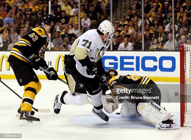 Tuukka Rask of the Boston Bruins makes a save against Evgeni Malkin of the Pittsburgh Penguins during Game Three of the Eastern Conference Final of...