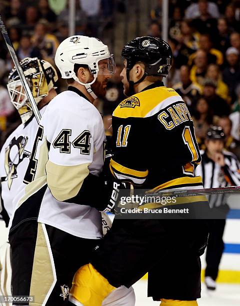 Brooks Orpik of the Pittsburgh Penguins and Gregory Campbell of the Boston Bruins get involved after the whistle during Game Three of the Eastern...