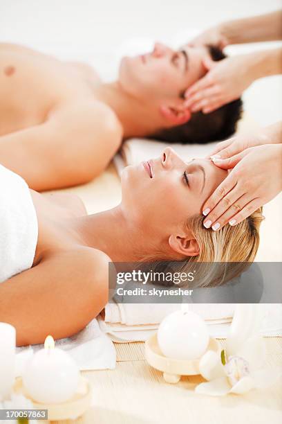 romantic couple is having a head massage at spa centre. - massage couple stock pictures, royalty-free photos & images