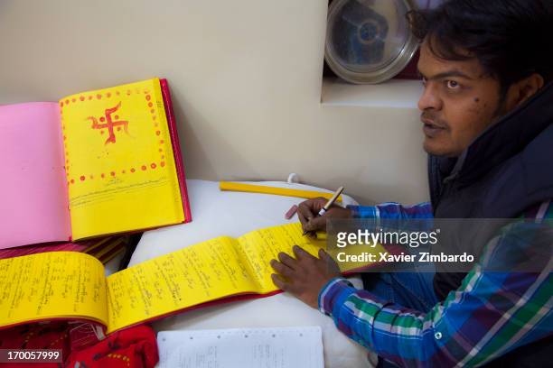 January 11: An accountant is at work on January 11, 2012 at a fabric fabric dyeing factory in Rajasthan, India. The yellow colour of account books is...