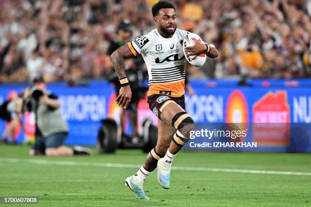 Ezra Mam of the Broncos runs with the ball during the 2023 NRL Grand Final match between Penrith Panthers and Brisbane Broncos at Accor Stadium in...