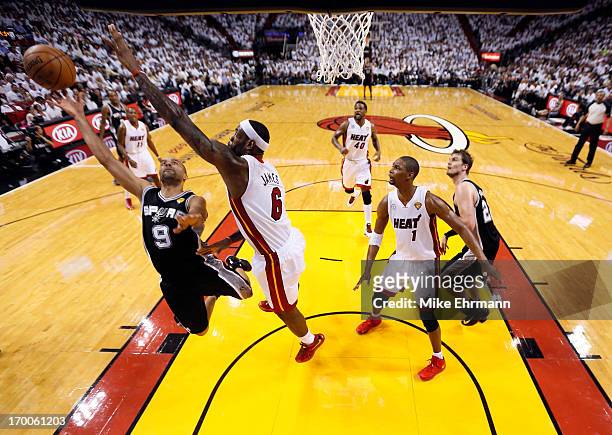 Tony Parker of the San Antonio Spurs goes up for a shot against LeBron James of the Miami Heat in the first quarter during Game One of the 2013 NBA...