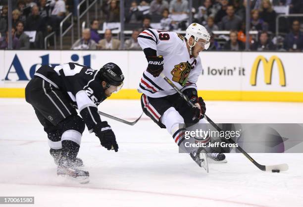 Jonathan Toews of the Chicago Blackhawks skates in alone on goal past Trevor Lewis of the Los Angeles Kings in the first period of Game Four of the...