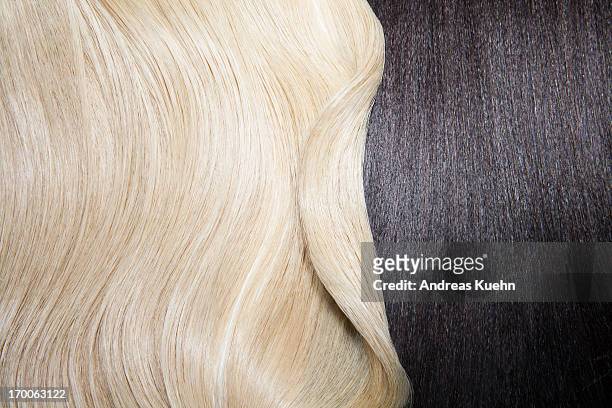 still life of two different hair colors. - blonde hair stock-fotos und bilder