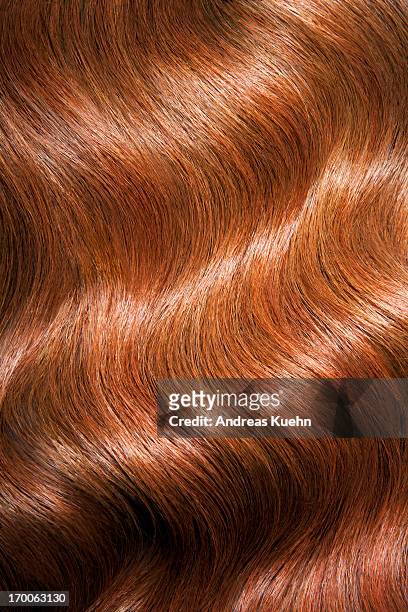 tight shot of wavy, shiny red hair. - haare stock-fotos und bilder